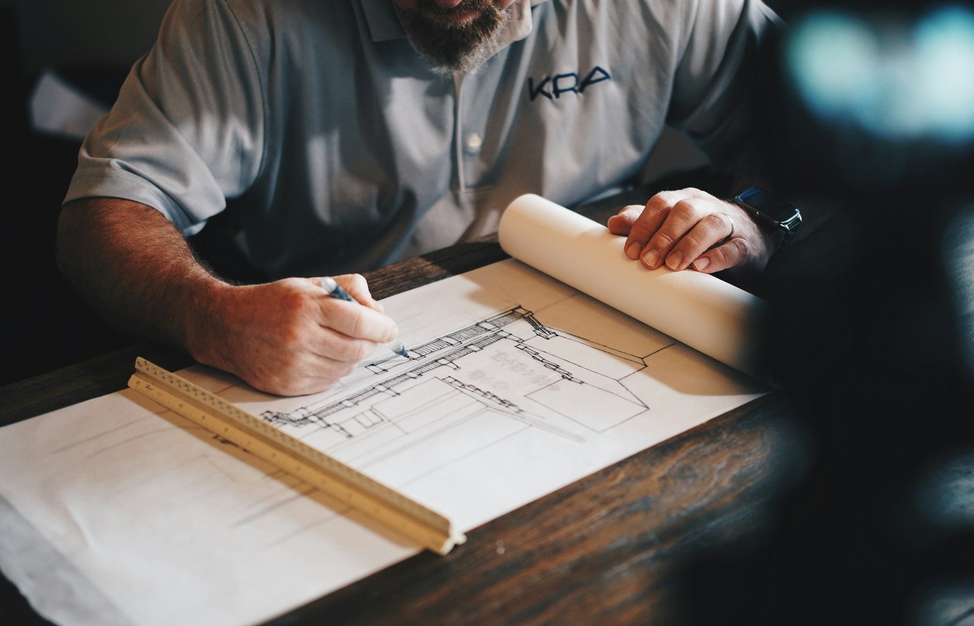 A maker drawing full-size plans at the bench