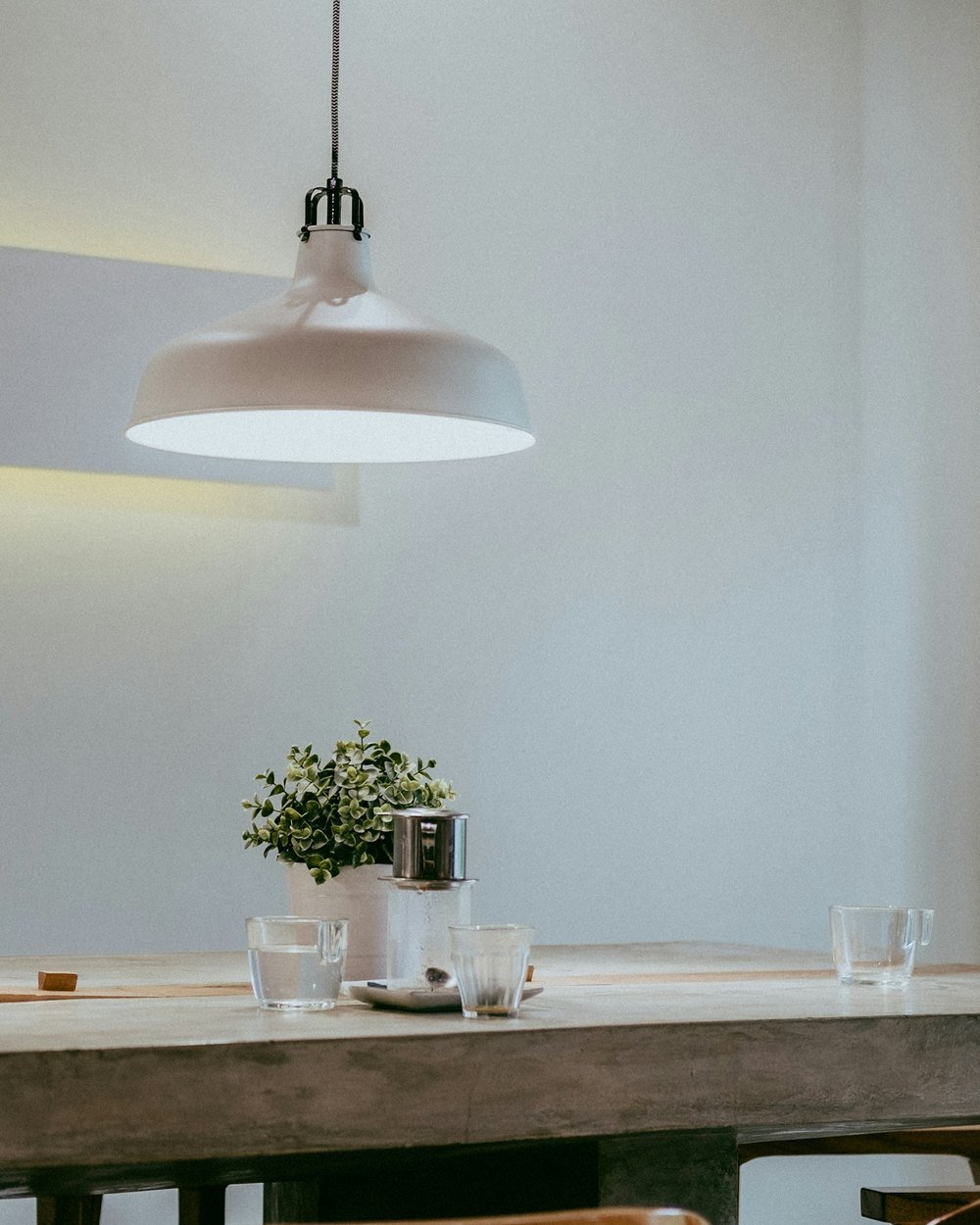 Pendant lighting above a long dining table