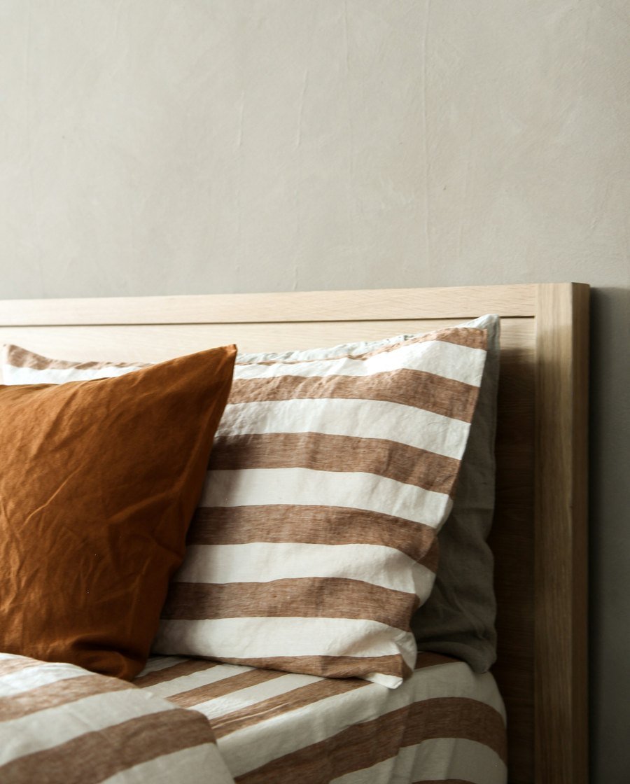 Striped linen on a solid oak bed frame
